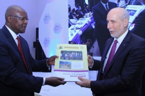 Justice Bart Katureebe handing over a copy of the 2018 - 2019 JLOS Performance Report to Amb. Atilio Pacifici Chairperson of the JLOS Development Partners Group at the 24th Annual JLOS Review on 12th November 2019 (PHOTO: JLOS)